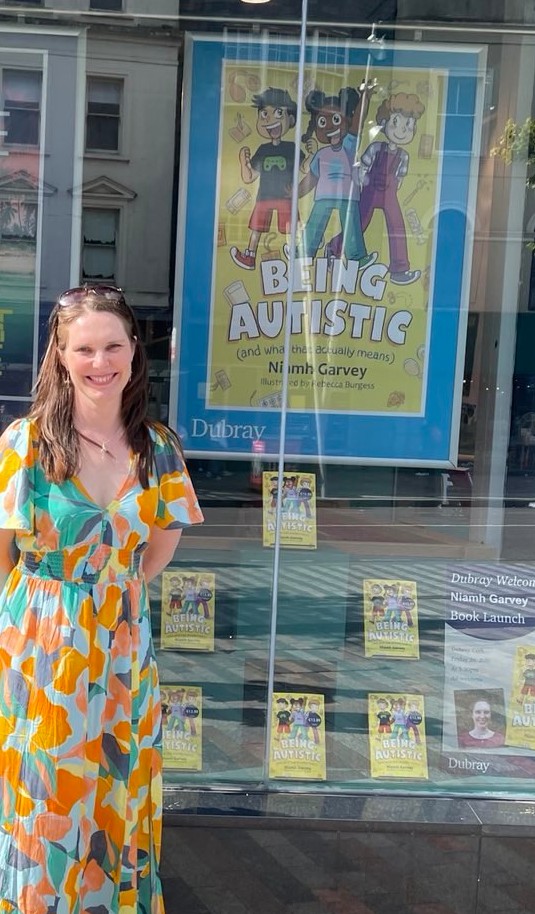 Photo of me standing outside Dubray bookshop's window.

In the window there is a large poster of my book "Being Autistic (and what that actually means)" plus a number of copies of the book.